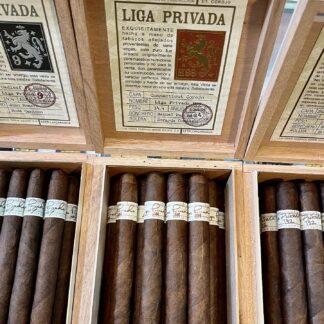 A close up of three boxes of cigars