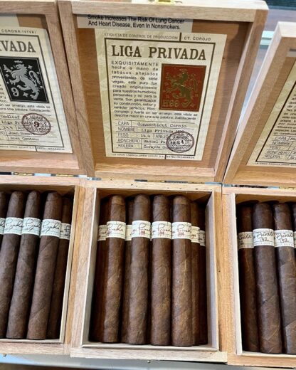 A close up of three boxes of cigars