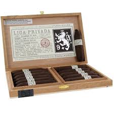A wooden box filled with lots of cigars.